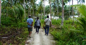 NZMATES team accompanied by ESDM staff and a local guide visiting the village coconut field