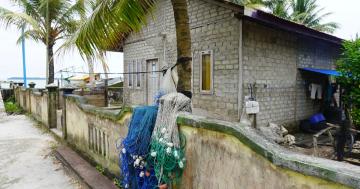 Fishnet in front of the house is a common view in this village filled with hardworking fishermen